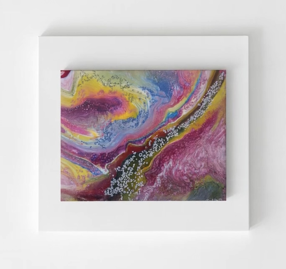 Vivid abstract painting of yellow, magenta, pink and blue currents crossed by a band of silver bubbles
